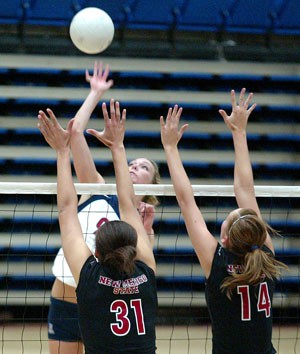 UA outside hitter Brooke Buringrud leaps to spike the ball over New Mexico State defenders March 29 in McKale Center. The Wildcats will be in San Diego this weekend for their second offseason tournament.