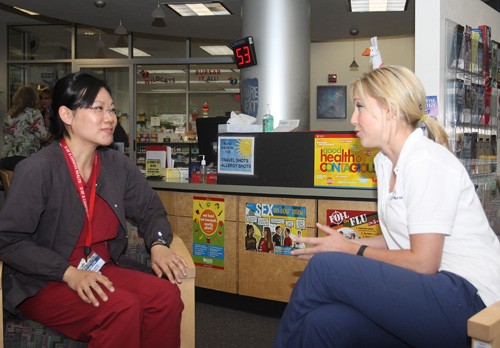 Timothy Galaz / Arizona Daily Wildcat
 During her clinical rotation Lindsay Galles, right, a senior majoring nursing, explains possible side effects of allergy injections to Campus Health Nurse Sharon Hom in the Campus Health Triage on March, 29, 2010.

