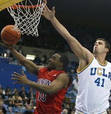 UA guard Nic Wise goes up for a layup past UCLA forward Nikola Dragovic during the Wildcats 82-60 loss to the No. 5 Bruins Feb. 3 in Pauley Pavilion. Arizona will be without its only true point guard for the next four to six weeks after Wise underwent knee surgery on Wednesday.