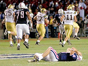 Arizonas Kris Heavner lies in angst after throwing an interception which was returned by UCLAs Rodney Leisle (77) for a touchdown late in UCLAs 24-21 win in Tucson, Ariz., October 11, 2003. It was Heavners third interception of the game. (Saul Loeb/Arizona Daily Wildcat)