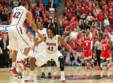 Jamelle Horne, left, and Jordan Hill celebrate a 96-90 overtime win against Houston in McKale Center on Saturday. The Wildcats scored 13 points in the final minute of regulation, and didnt allow a Cougar field goal in overtime.