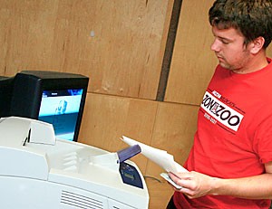 Greg Ralbovsky, a journalism junior, prints an article for his English class yesterday at the Office of Student Computing Resources lab inside La Paz Residence Hall. Printing at OSCR labs, once free on Thursdays, is now 10 cents a page all the time.