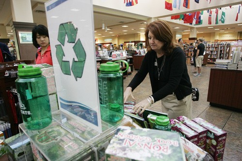 Kitty Martinez, Customer Service Manager for UofA Bookstores adds the final touches to the going green display in the main bookstore Tuesday afternoon. 

Mike Christy/Arizona Daily Wildcat