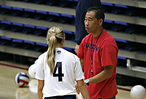 Arizona head coach Dave Rubio directs libero Katie Jackels on the sidelines during practice Tuesday in McKale Center. The volleyball team will travel to Malibu, Calif., where it will compete against Pepperdine, the team Rubio got his first victory  against as a Wildcat coach.