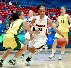UA guard Tasha Dickey (13) drives around Oregon guard Taylor Lilley in a 59-53 loss to the Ducks on Jan. 5 in McKale Center. The daughter of two former Arizona athletes, Dickey claims she was destined to be a Wildcat.