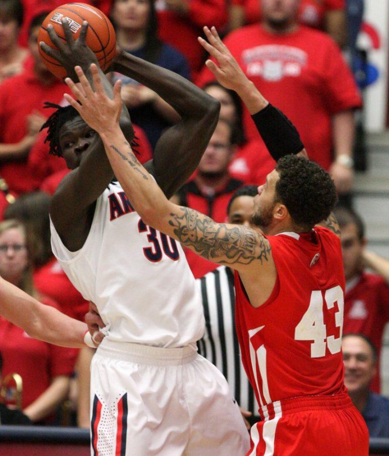 Colin Darland / Daily Wildcat

Arizona freshman forward Angelo Chol, 30, is defended by two Utah players in the opening minutes of the Wildcats match-up against the Utah Utes in McKale Center on Saturday, February 11, 2012. 
