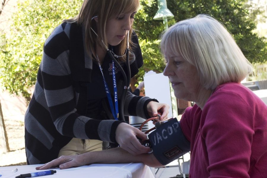 Lydia Stern / Arizona Daily Wildcat

Kayla Ward, first-year pharmacy student, checks the blood pressure of Anne Sunderland at the Health and Wellness Forum.  Various health organizations gather at the forum each year to focus on educating the community about health.