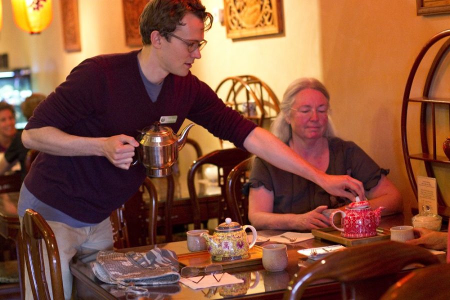 Lydia Stern/Daily Wildcat

Andrew Mcneill, an East Asian Studies junior, serves tea to Zita Ingham at Seven Cups on Wednesday.