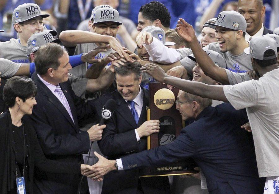 The+Kentucky+team+mobs+coach+John+Calipari+after+being+awarded+the+championship+trophy+following+a+67-59+win+over+Kansas+in+the+NCAA+Tournament+finals+at+the+Mercedes-Benz+Superdome+on+Monday%2C+April+2%2C+2012%2C+in+New+Orleans%2C+Louisiana.+%28John+Sleezer%2FKansas+City+Star%2FMCT%29