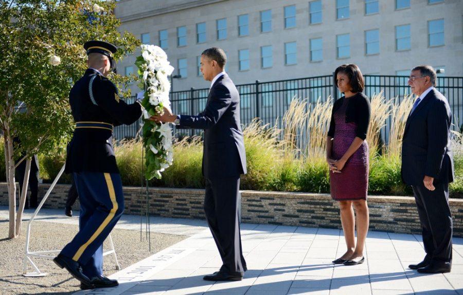 President Barack Obama with first lady Michelle Obama and Secretary of Defense Leon Panetta, right, commemorate the 11th anniversary of the 9/11 attacks with a wreath laying ceremony at the Pentagon, Tuesday, September 11, 2012, in Arlington, Virginia. (Olivier Douliery/Abaca Press/MCT)