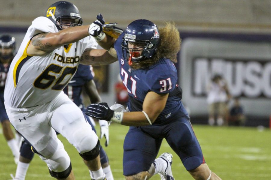 Larry Hogan/Arizona Daily Wildcat

Defensive lineman Taimi Tutogi, No. 31, attempts to get past Toledos offensive line during Saturdays 24-17 overtime win.