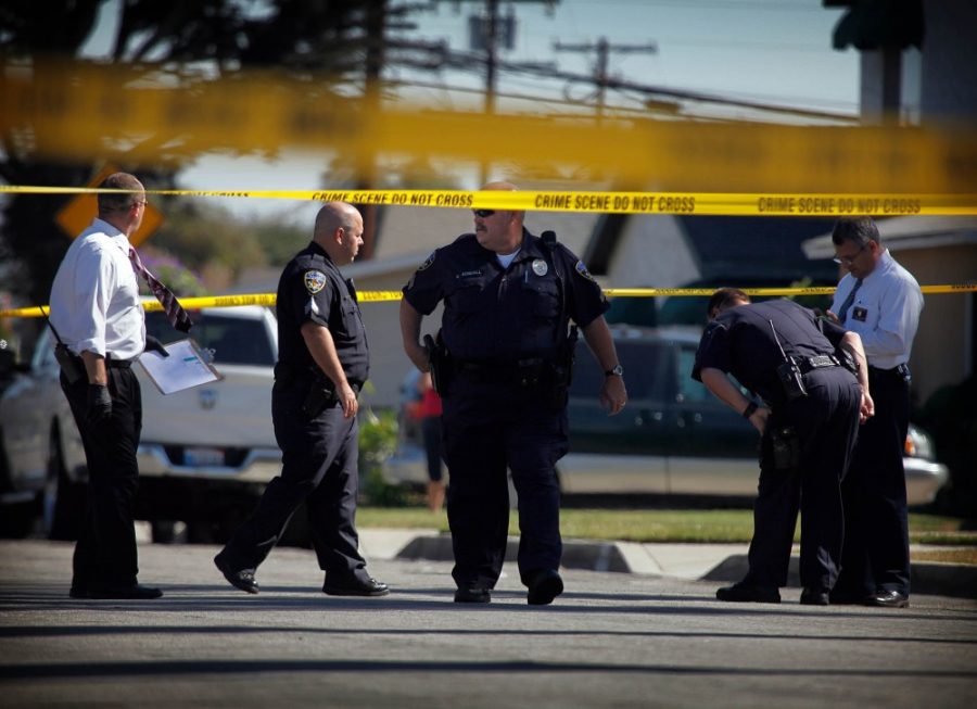 Police examine the scene at a house in Downey, California, on Wednesday, October 24, 2012. Three people have died and two others have been hospitalized in a pair of related shootings. (Barbara Davidson/Los Angeles Times/MCT)