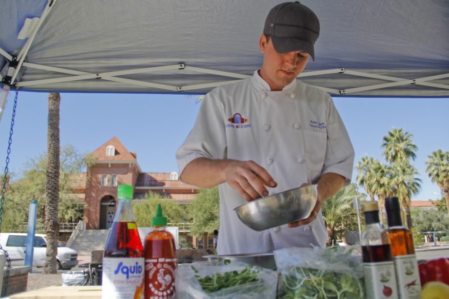 Noelle R. Haro-Gomez /  Arizona Daily Wildcat

Executive Chef Ryan Clark from Lodge on the Desert demonstrates to UA students how to make Asian Noodle Salad at UA Food Day. Clark is a two time Iron Chef Tucson winner.