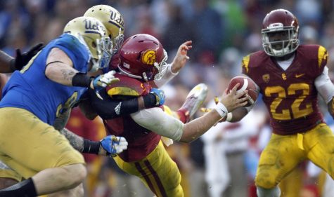 UCLA linebacker Anthony Barr (11) and  defensive end Cassius Marsh (99) sack USC quarterback Matt Barkley in the second half at the Rose Bowl on Saturday, November 17, 2012, in Pasadena, California. UCLA knocked off the Trojans, 38-28. (Gina Ferazzi/Los Angeles Times/MCT)