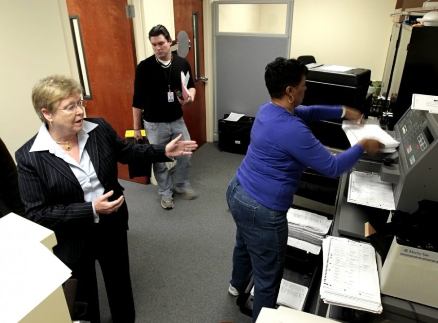 Liz Crum, left, chairperson of the Richland Co. Election Commission, answers media questions as employees continue counting absentee votes after the scanner that tallies the ballots was fixed, Wednesday, November 7, 2012, in Columbia, South Carolina. There were still about 35,000 votes to count. (Tim Dominick/The State/MCT)