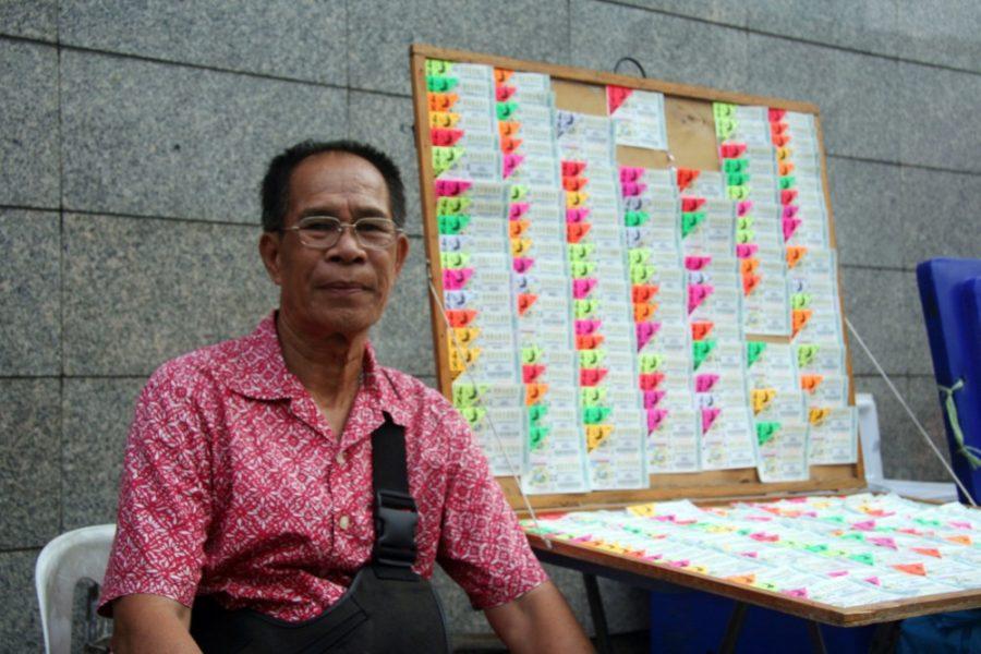 Lottery ticket vendors on the streets of Bangkok are concerned they will lose their jobs if a government plan to introduce lottery machines goes into effect. (Mark Magnier/Los Angeles Times/MCT)