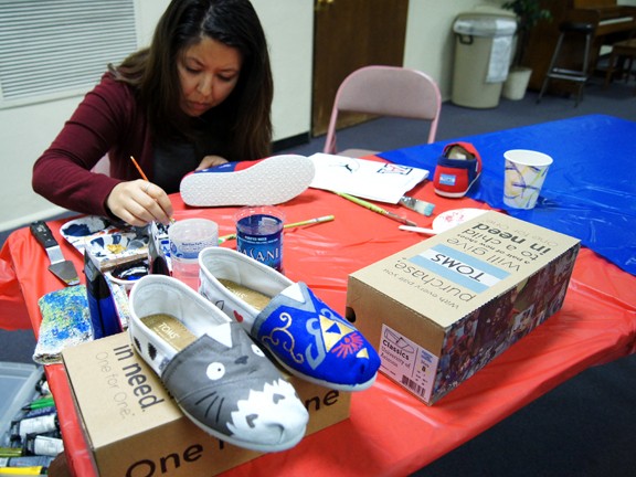 Gabriela Diaz /  Arizona Daily Wildcat

Toms hosts an event to add custom designs to their shoes and promote their brand. The event was held at St Thomas More Catholic Newman Center and included live performances, food and freebies. 