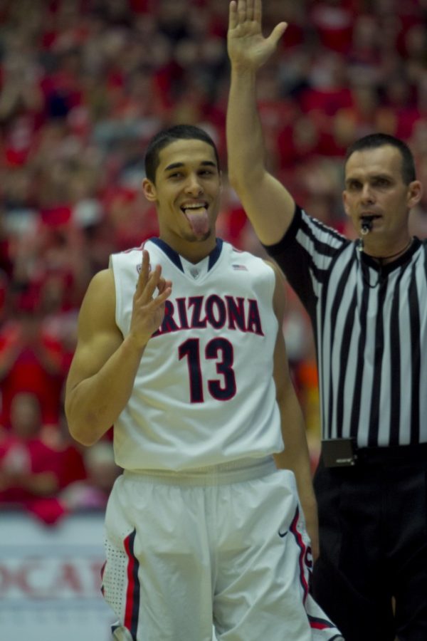 	Nick Johnson celebrates a three-pointer he made for the Arizona Wildcats against ASU on Saturday, March 9, 2013. Arizona won the game 73-58 at McKale Center.