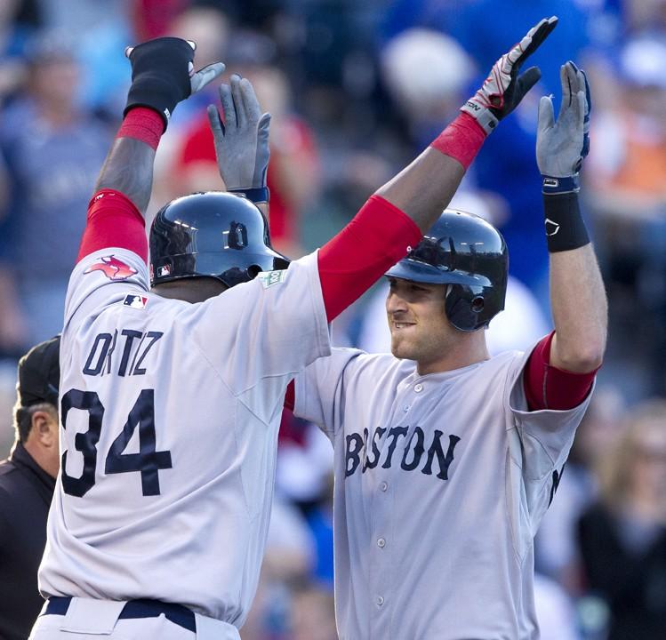Will Middlebrooks, right, of the Boston Red Sox is congratulated by teammate David Ortiz (34) after hitting a three-run home run against the Kansas City Royals in the first inning on Monday, May 7, 2012, in Kansas City, Missouri. (John Sleezer/Kansas City Star/MCT)