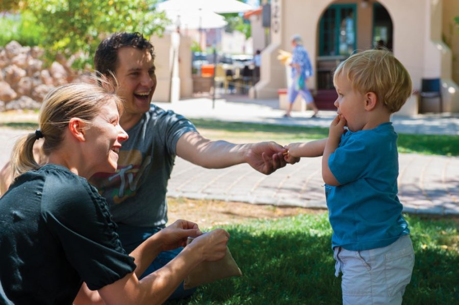 Tyler Besh / Arizona Daily Wildcat

Tucson residents Kristy Kohler and husband Alan Kohler play with 18 month old son Henry in Main Gate Square on Tuesday April 16, 2013. 