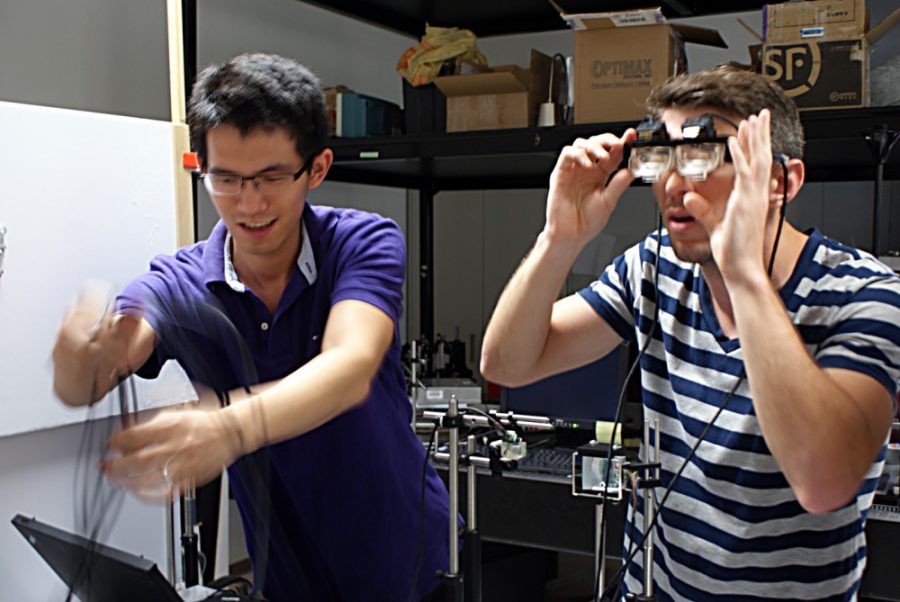 Savannah Douglas /  The Daily Wildcat

Yi Qin (left) and Jason Kuhn (right) are both students of optical engineering at the University of Arizona. Qin and Kuhn are able to work in a lab located in the Meinel Optical Sciences building to design a heads up display. 