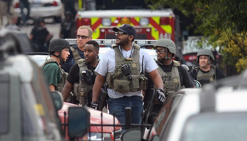 Law enforcement personnel respond to an attack on office workers at Washington Navy Yard Monday morning, September 16, 2013. A gunmen opened fire and killed at least 12 people in the attack in Washington, D.C. (Olivier Douliery/Abaca Press/MCT)