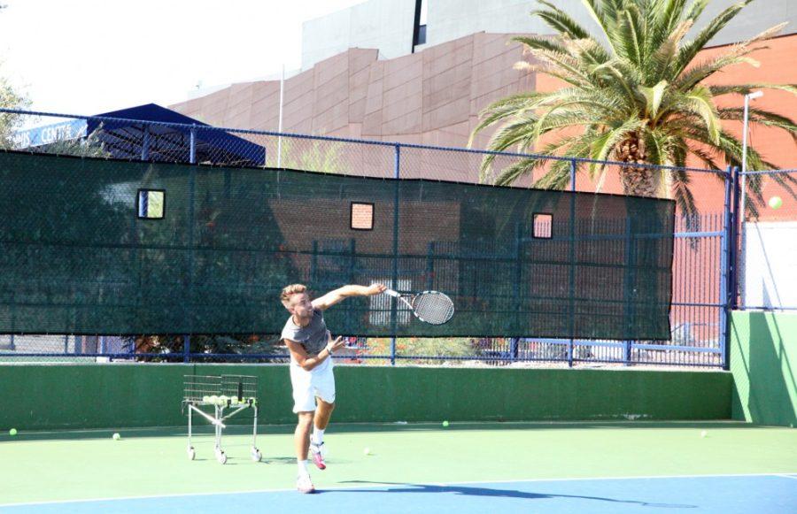 Shane Bekian / The Daily Wildcat

Fredrik Ask, a Business Economics junior, serves the ball to his teammate during the Mens Tennis Team practice on Friday. 