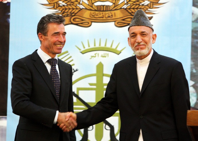 Afghan president Hamid Karzai (right) shakes hands with NATO Secretary General Anders Fogh Rasmussen after a press conference in Kabul, Afghanistan on June 18, 2013. Afghan national forces will lead all military operations in the country from June 19, Afghan President Hamid Karzai said on Tuesday. (Ahmad Massoud/Xinhua/Zuma Press/MCT)