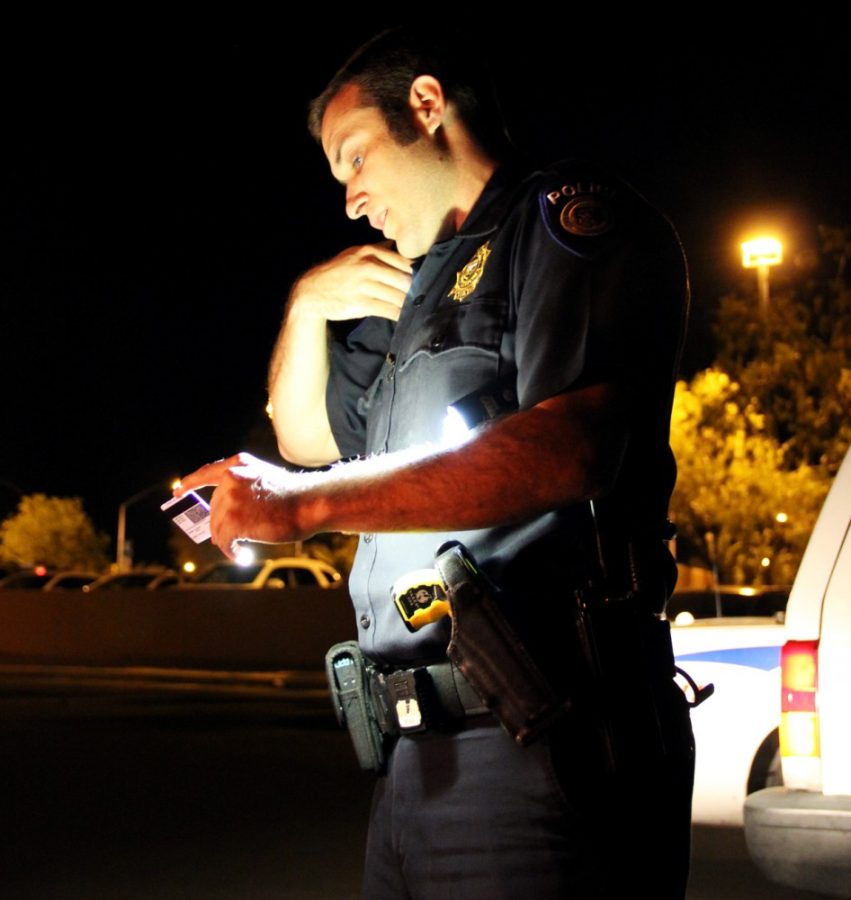 Mark Armao/ The Daily Wildcat

Nathan Venger, a University of Arizona Police Department officer gathers a bus drivers information after the driver sideswiped a fire engine on campus. Venger is also a pre-pharmacy student at the UA.