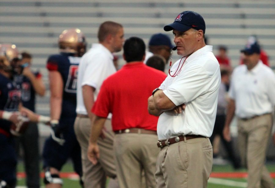 Tyler Baker/The Daily Wildcat

UA Football Coach, Rich Rodriguez, watches his team warmup before the NAU game on Aug. 30, 2013.