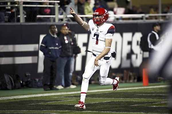 Quarterback B.J. Denker (7) points to the Arizona fans after scoring a touchdown during a game between Colorado and Arizona at Folsom Field, Saturday, Oct. 26, 2013. (Kai Casey/CU Independent)