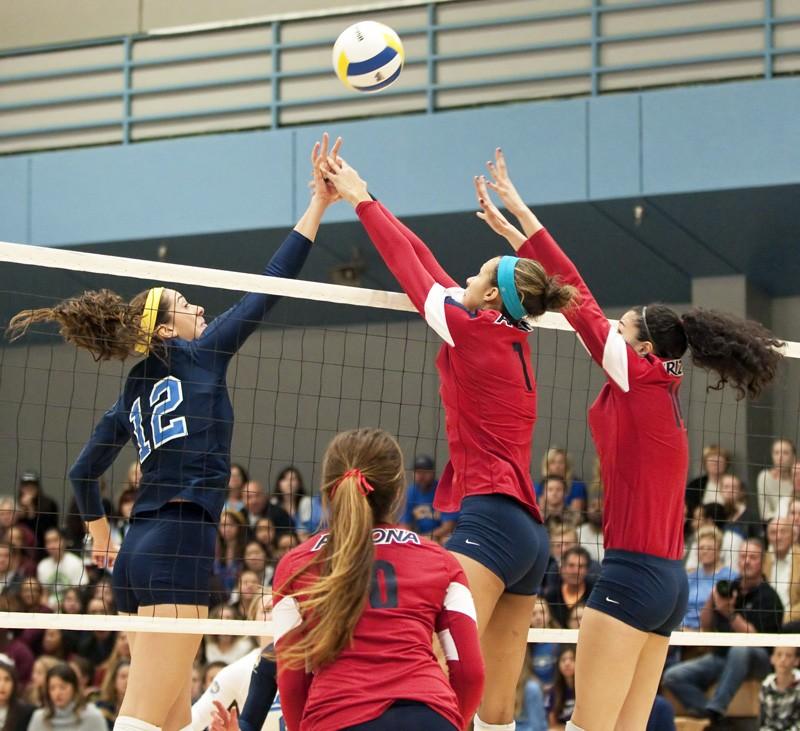 Photo courtesy of Miriam Bribiesca/Daily Bruin

Olivia Magill (left) and Taylor Arizobal (right) jump to block the ball against UCLA on Sunday in Los Angeles.  
