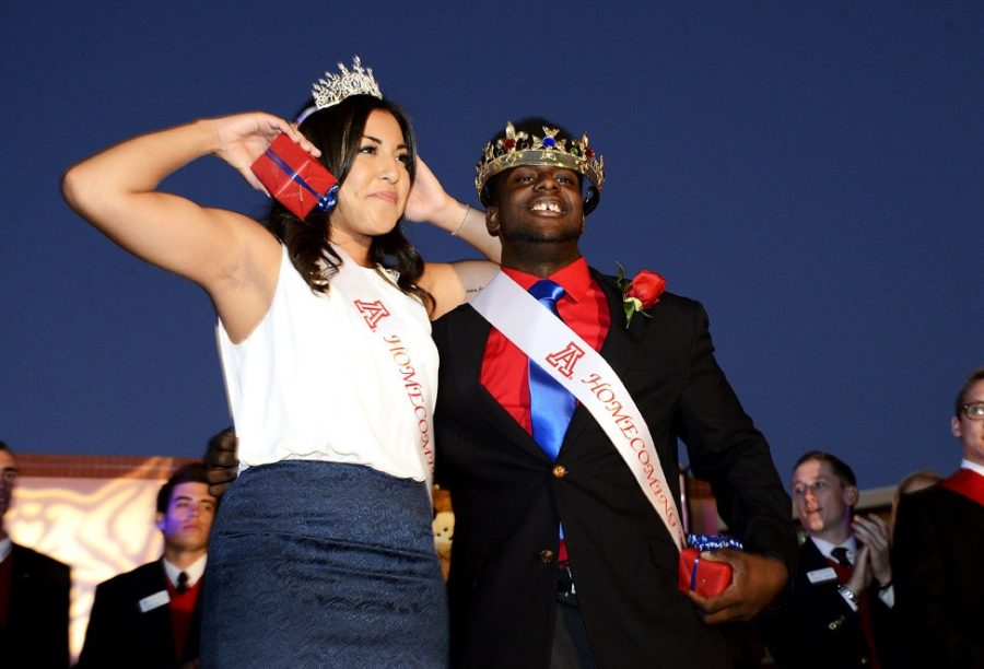 Ryan Revock/The Daily Wildcat

Alexis Del Castillo (left), an English and and creative writing senior. and Courtney James Broome (right), a psychology senior, stand on the after being named the 2013 Homecoming king and queen on Thursday at Main Gate Square.  

