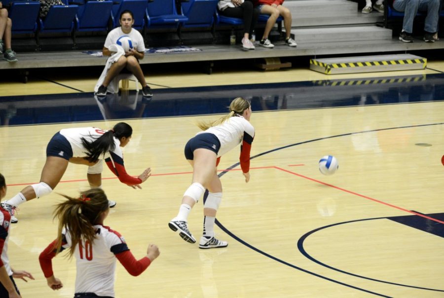 Ryan Revock  / The Daily Wildcat

Penina Snuka (left) and Madi Kingdon (right) dive to try to return the ball on Suday at the McKale Center.