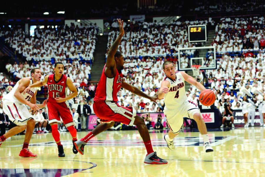 Ryan Revock / The Daily Wildcat

UA junior guard T.J. McConnell drives the ball past UNLV defenders towards the basket on Saturday in the McKale Center.  
