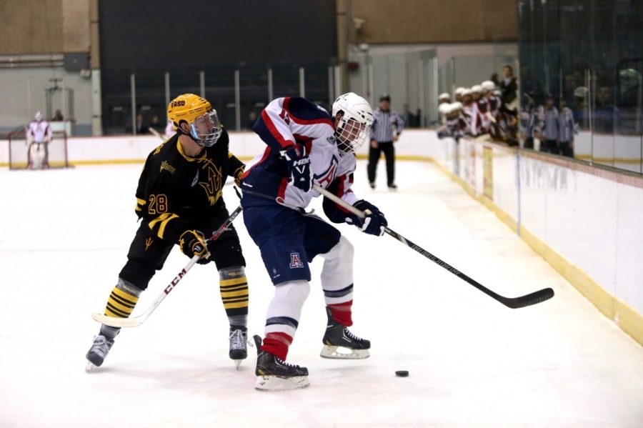 Keenan Turner/ The Daily Wildcat

ASUs Michael Cummings fights for the puck from UAs Wil Pointon on Friday at the TCC.