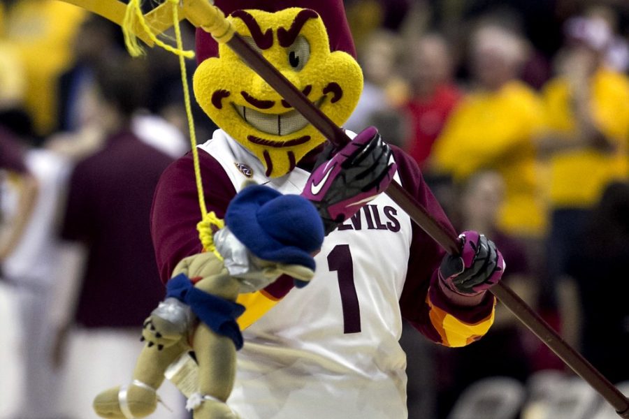 Tyler Besh /  Arizona Daily Wildcat

Sparky, the ASU mascot, holds Wilbur from his pitchfork. Recently, ASU fans have become more aggressive towards UA students at basketball games. 