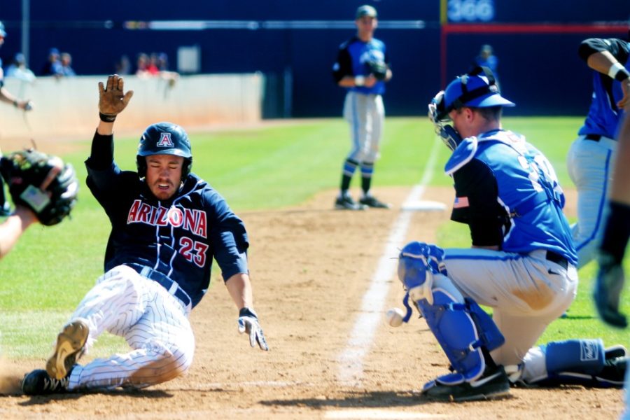 Cecilia Alvarez/ The Daily Wildcat

Sophomore Zach Gibbons begins to slide into home plate during Arizonas 10-2 win against Air Force at Hi Corbett Field on Wednesday. 