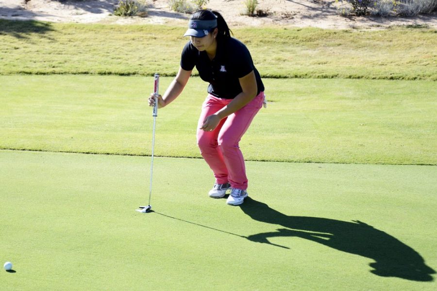 	File Photo / The Daily Wildcat 

	Freshman Wanasa Zhou lines up her shot during practice at Sewailo Golf Club. Zhou is one of three international players on the seven-member women’s golf team.