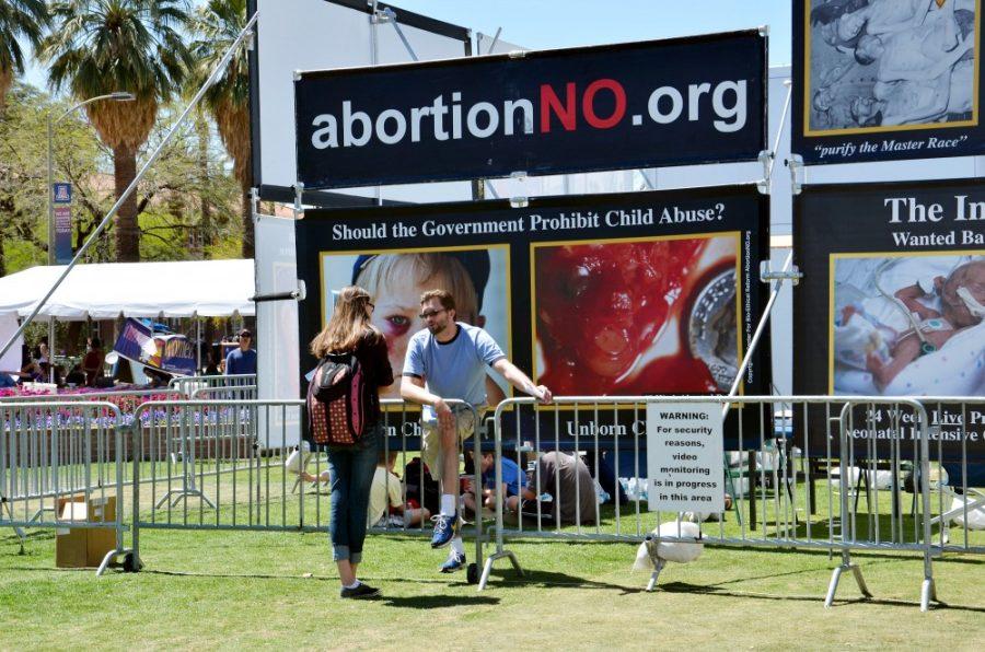 Rebecca Noble / The Daily Wildcat

Anti-abortion protestor Jason Walsh, director of the Arizona Right to Life, speaks with nutritional science sophomore Martina Sepulveda on the UA Mall on Tuesday, April 1st. The protest was put on and brought to the UA by the Center of Bioethical Reform.