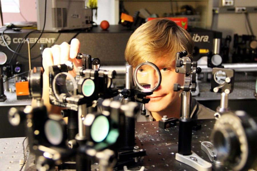 	Maik Scheller, an assistant research professor in the College of Optical Sciences, adjusts instruments in his laboratory. Scheller is the first author of a recently published study that looks at a new type of laser that could one day be used to divert lightning away from buildings.