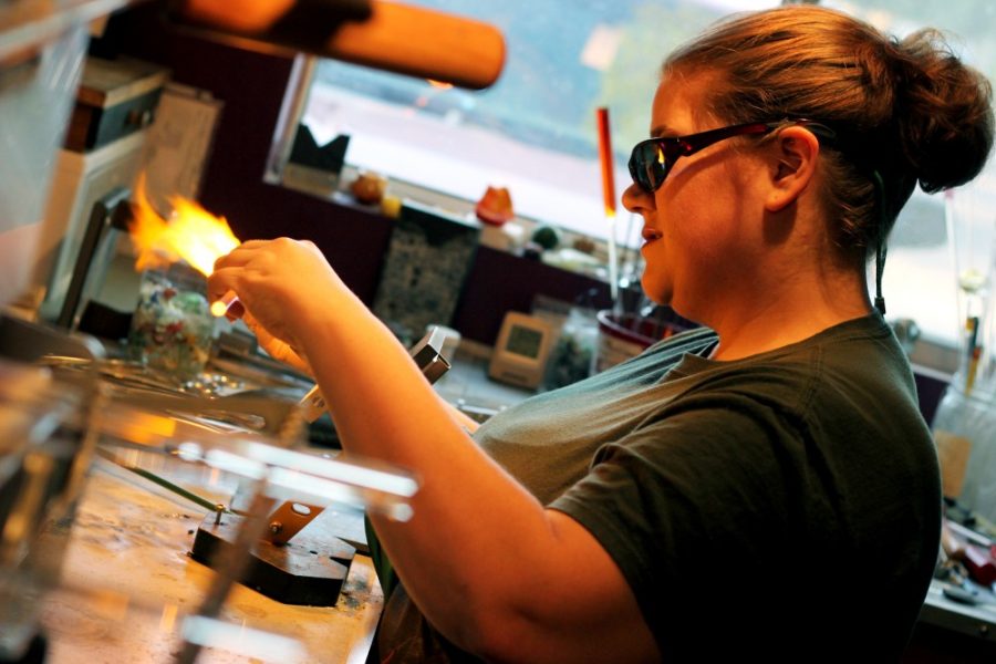 Rebecca Marie Sasnett/ The Daily Wildcat

Margaret Zinger, flame-work glass artist, heats up a piece of glass into a glass butterfly using a bench burner and hand touch in her studio on the east side of town Thursday.  