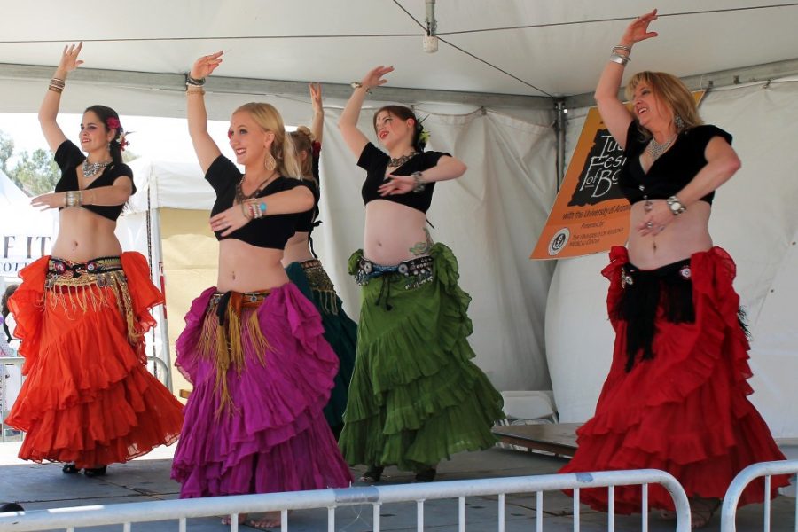 	Courtesy of Ashley Grove
Belly dancers dance at the Tucson Festival of Books on the UA Campus in March. The Fire & Gold Belly Dance troupe performs at venues throughout the Southern Arizona area. 