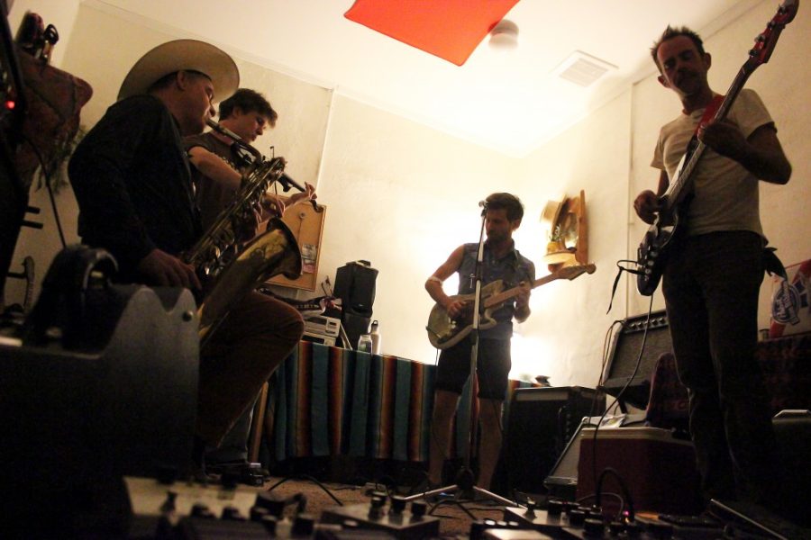 	Saxophonist Jeff Grubic, violinist Sasha Tolstoshev, guitarist and singer O Ryne Warner and bassist Ryen Eggleston, all members of OHIOAN, practice their new song “Bad Altitude” in their studio on Thursday evening. OHIOAN and five other bands will come together for a concert under the stars on Saturday at Cowtown Keeylocko’s working ranch.