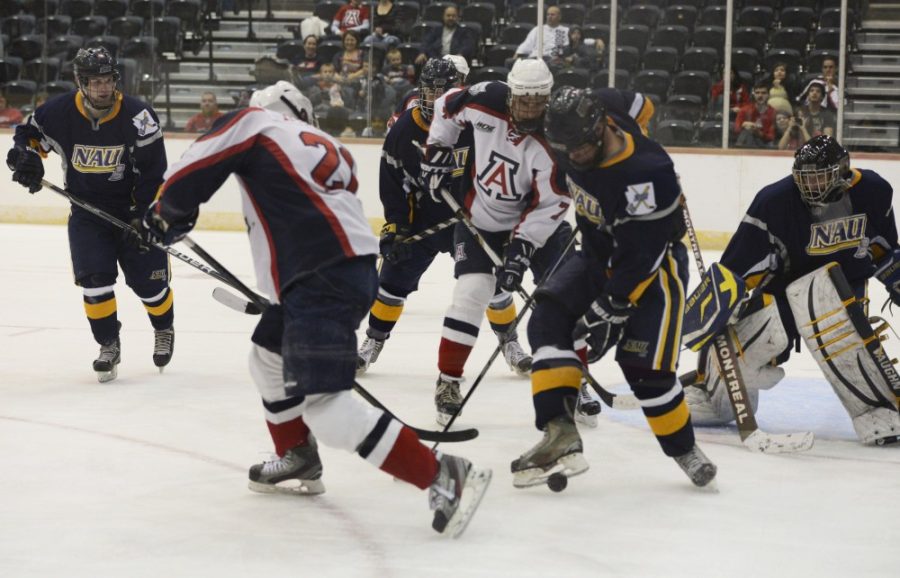 	Arizona hockey forward Alex O’Dea fights for the puck during a game against NAU. O’Dea and defenseman Alex Vazquez will play in the East Side Elite Hockey League in Michigan this summer. 