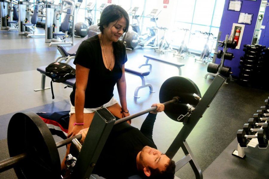 Grace Pierson / The Daily Wildcat

Jenkin Williams, a trombone
performance sophomore, bench presses while research assistant Jocelyn
Cruz, a molecular and cellular biology junior, sits on his lap. The two
are part of an experiment testing whether or not testosterone levels
rise when a woman sits on a mans lap as he bench presses, promoting
strength and muscle growth. The experiment was inspired by a meme
circling the internet. 