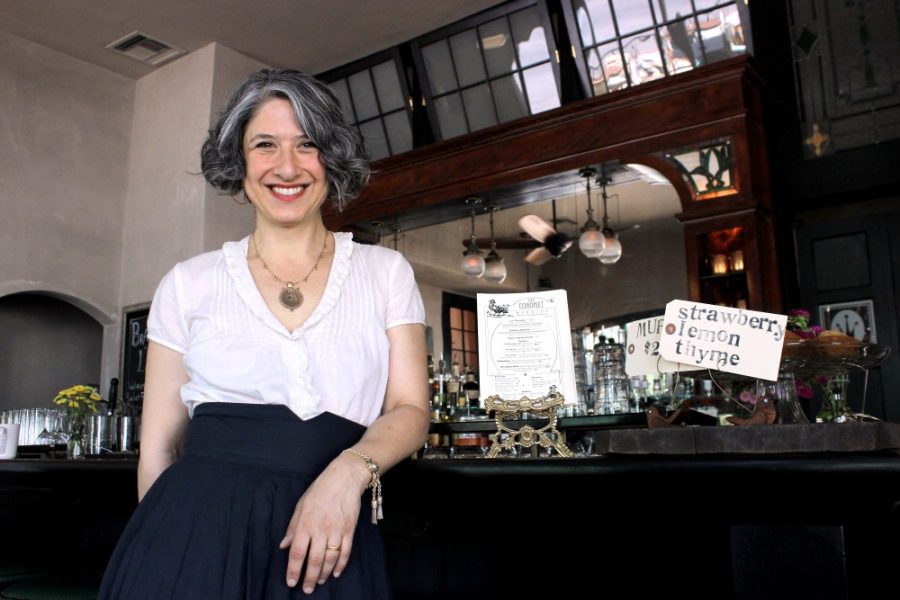 	Sally Kane, owner of The Coronet, stands at the bar of her cafe on Fourth Avenue and Ninth Street. Kane’s European styled cafe features live music on Wednesday nights. 