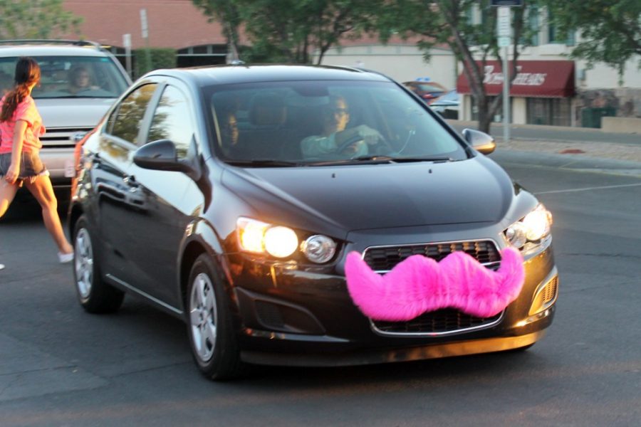 	A Lyft employee drives a student down Tyndall Avenue on April 16, 2014. Local cab drivers in the UA community have recently been writing on their vehicles to not take Lyft or Uber.