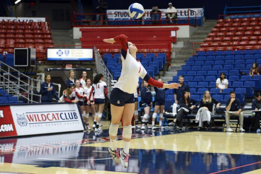 	Then-junior Ronni Lewis (1) spikes the ball during the UA’s 3-0 win against Utah on Nov. 14, 2013 in McKale Center. Lewis earned the
starting libero spot this year. 