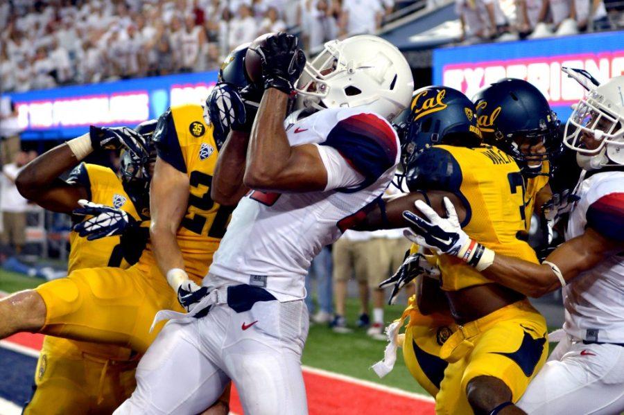 	Arizona won 49-45 against Cal during UA footballs first white game  and first Pac-12 conference game at Arizona Stadium on Saturday, Sept. 21, 2014. Cal took the lead in the first quarter and maintained that lead through all four quarters except the last second of the 4th quarter. Arizona redshirt senior Austin Hill (29) caught the ball in the end zone when the time clock hit 0:00. 